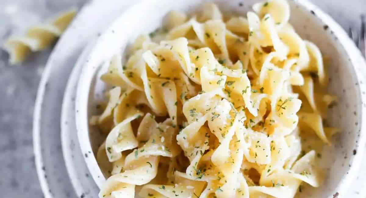Overhead image of cheesy garlic buttered noodles.