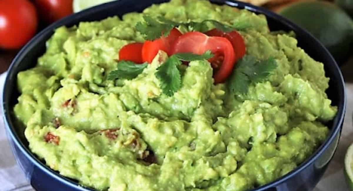 Overhead image of easy guacamole recipe with garnish.