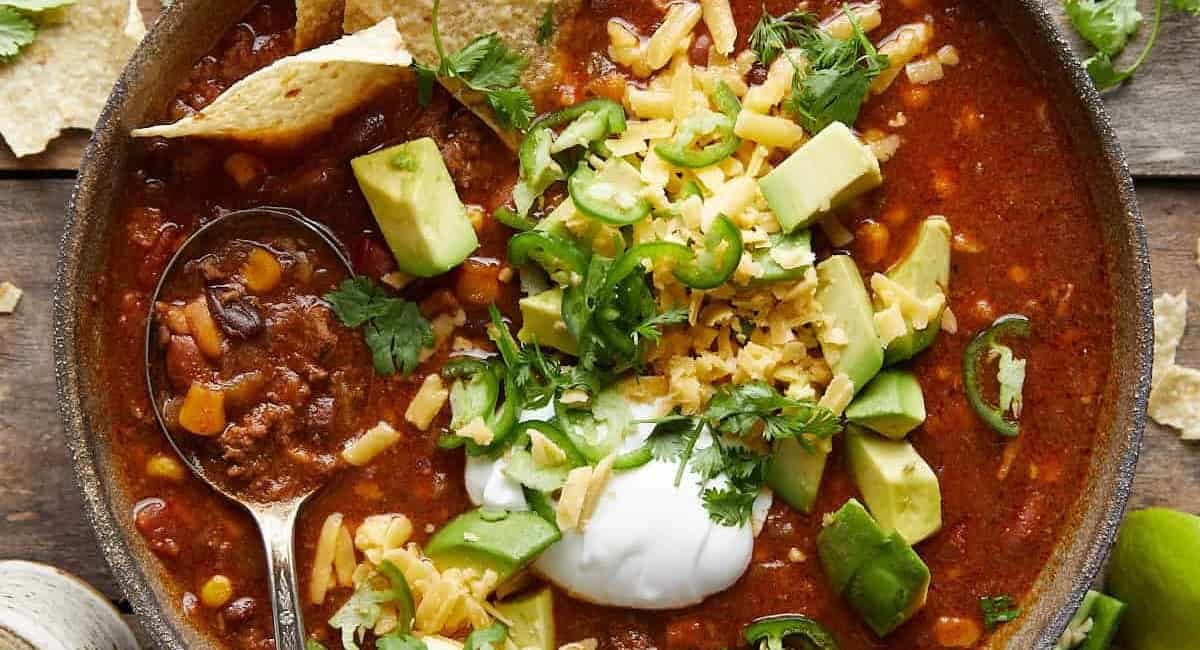 Overhead iamge of 7 can taco soup with garnish.