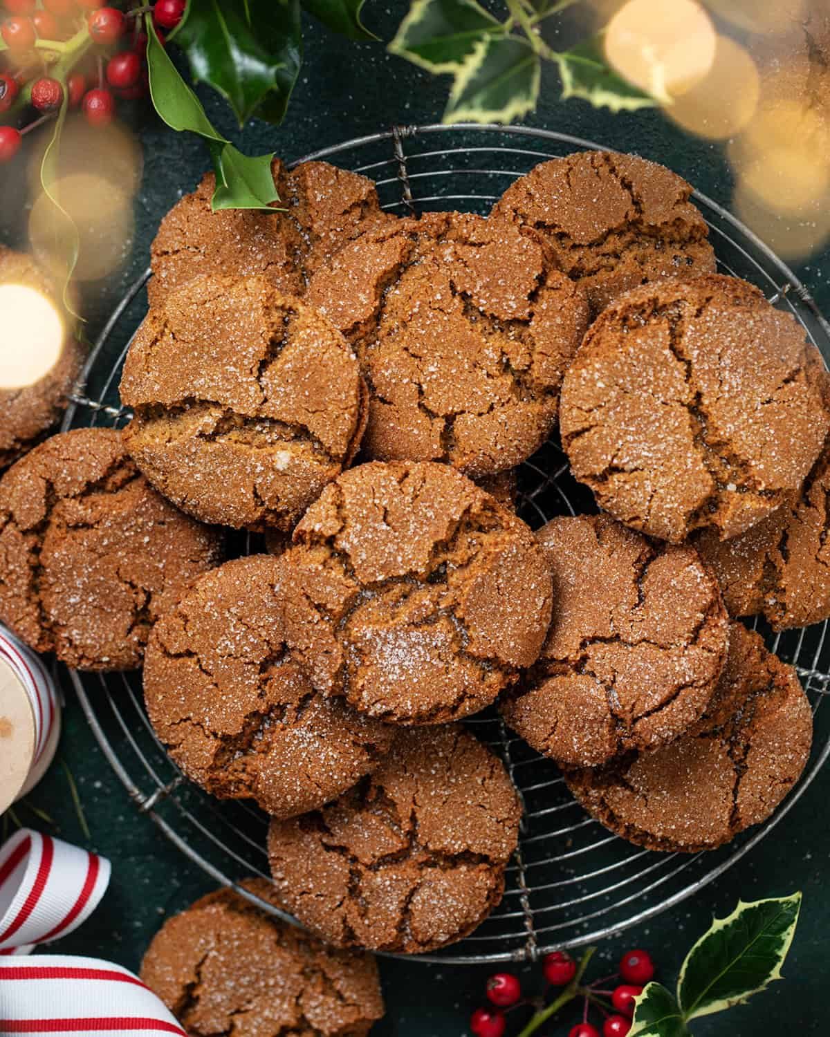 Overhead image of old fashioned ginger snaps with Christmas decor surrounding cookies.