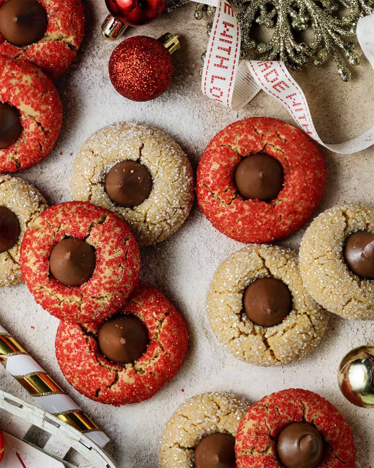 Overhead image of Christmas peanut butter blossoms with Christmas decor surrounding.