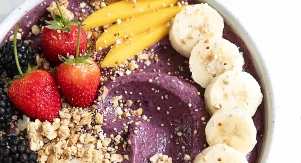 Overhead image of acai bowl with fruit garnish.