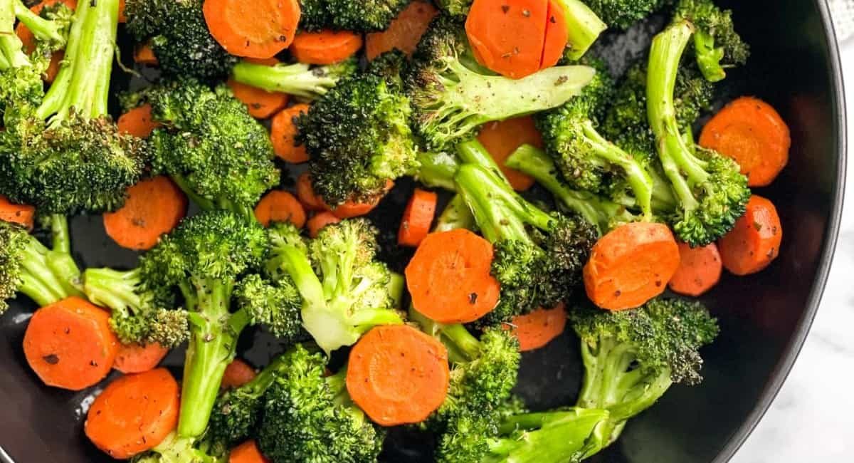 Overhead image of air fryer broccoli and carrots.