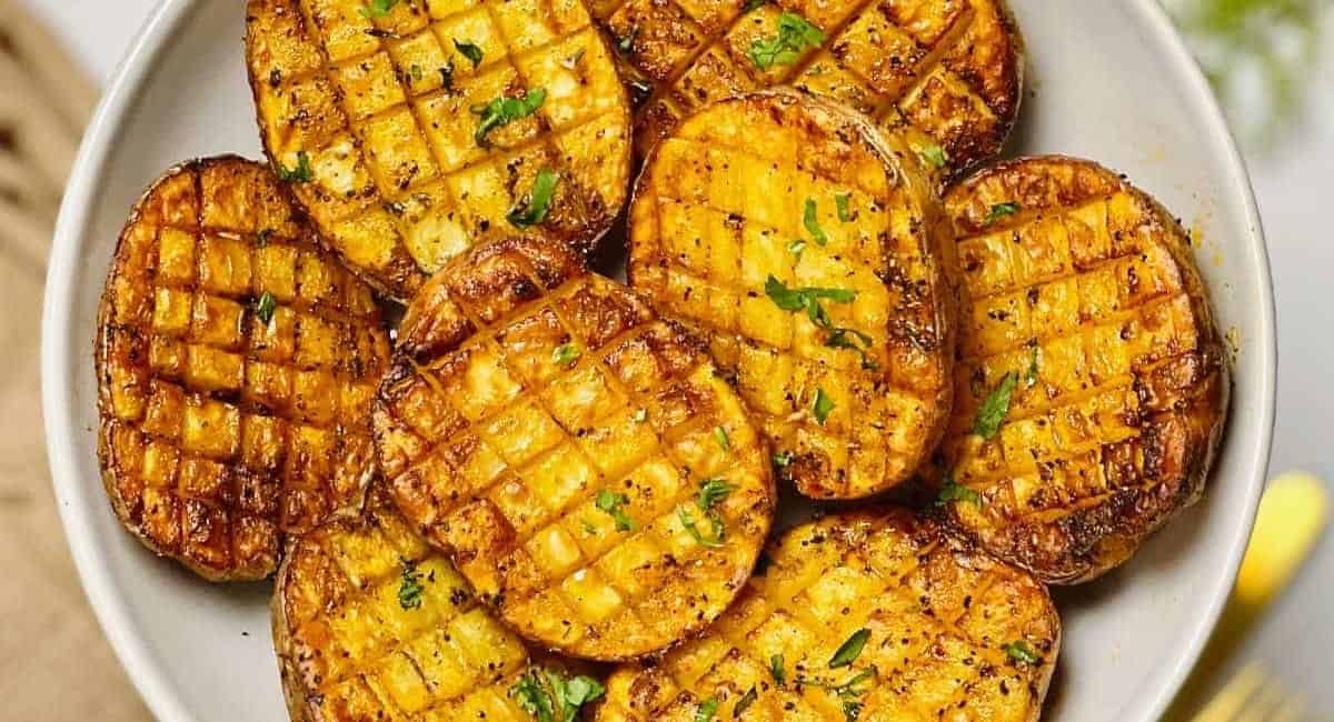 Overhead image of air fryer criss cross potatoes.