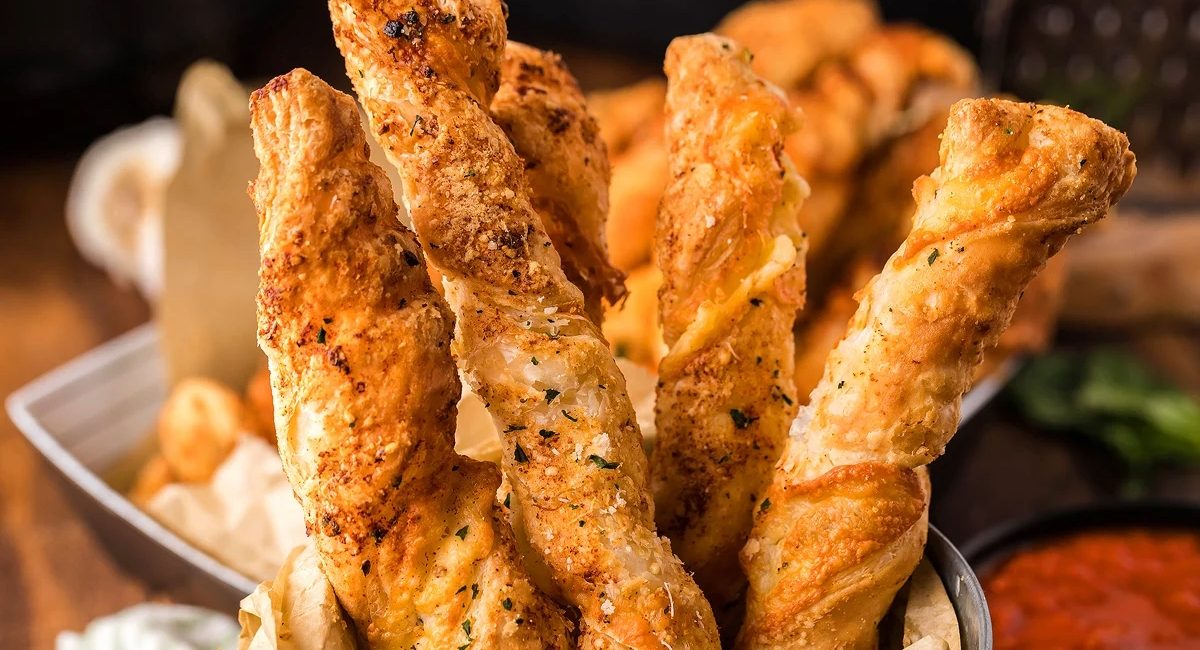 Up close image of air fryer puff pastry cheese twists.