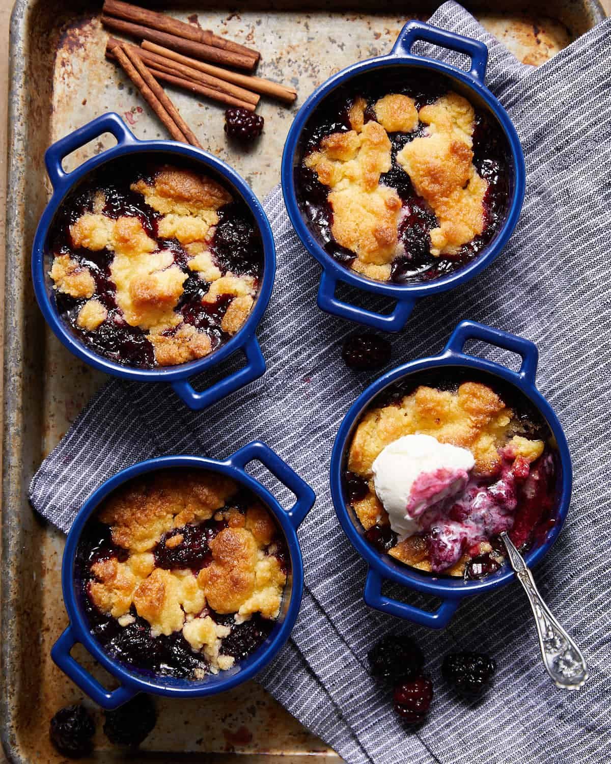Overhead image of air fryer blackberry cobbler in blue dishes.