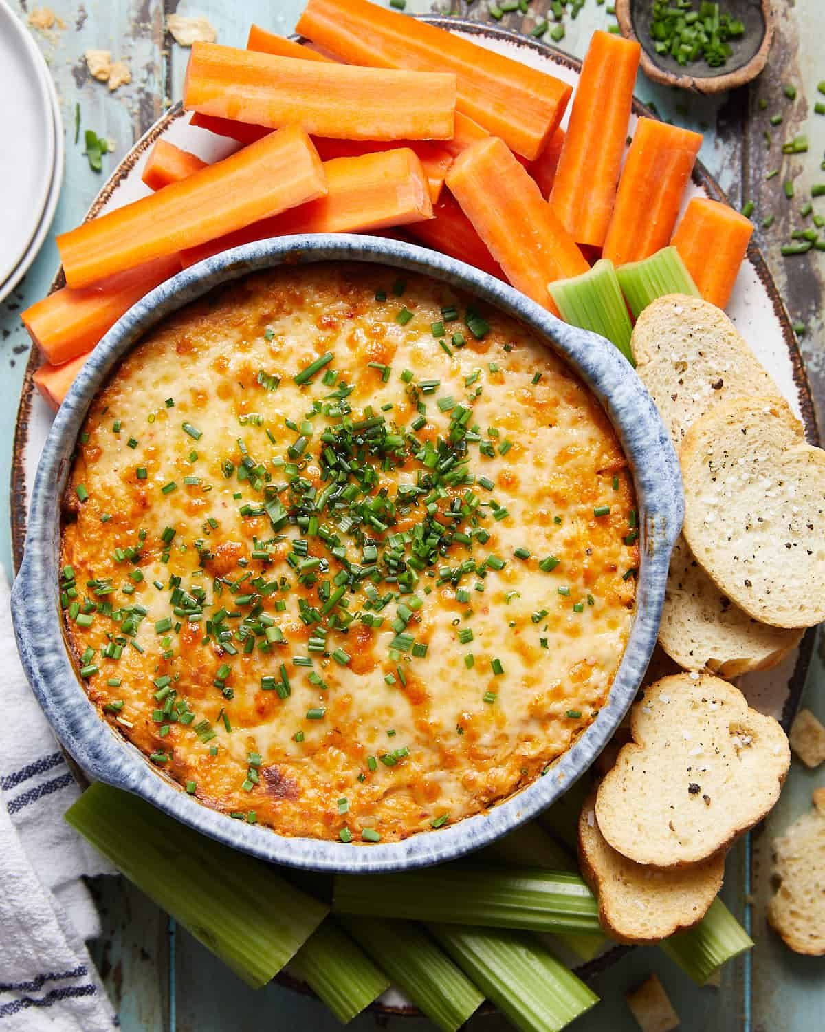 Overhead image of air fryer buffalo chicken dip with garnish.
