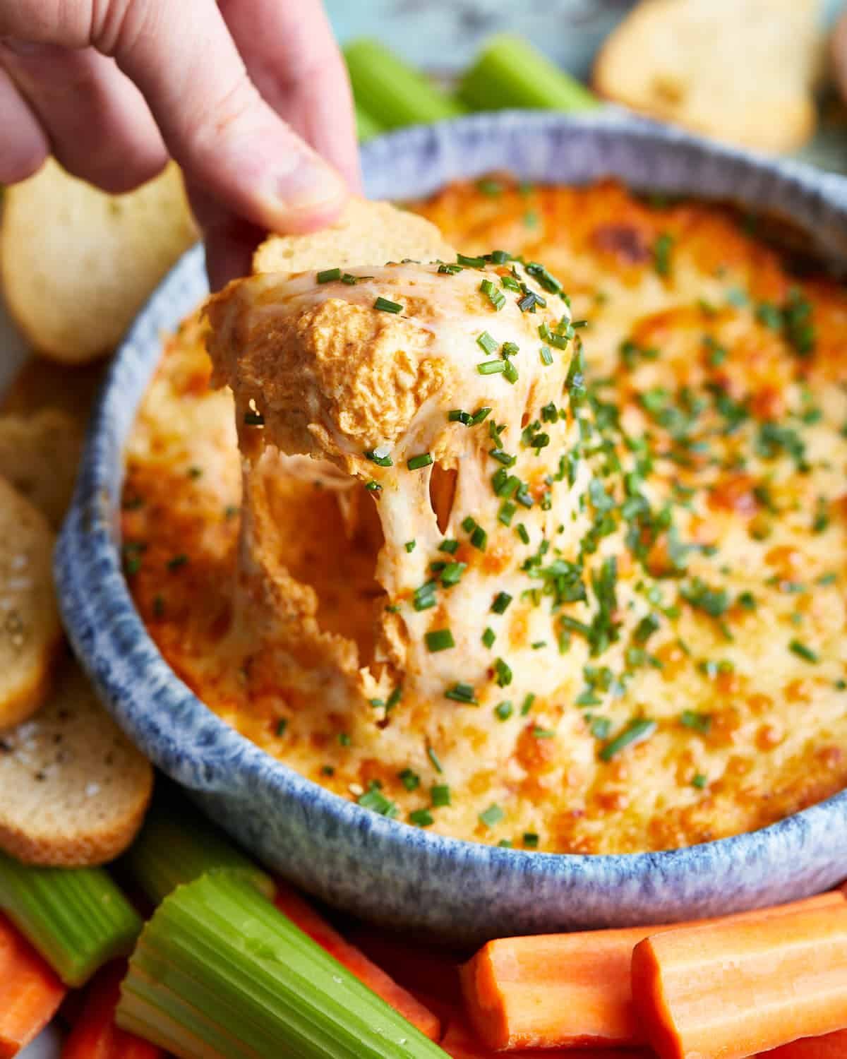 Up close image of air fryer buffalo chicken dip in blue dish.