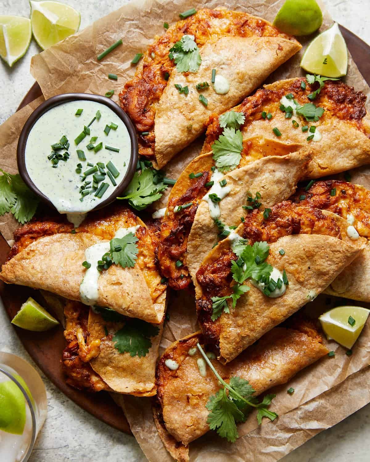 Air fryer buffalo chicken tacos on plate with homemade ranch.