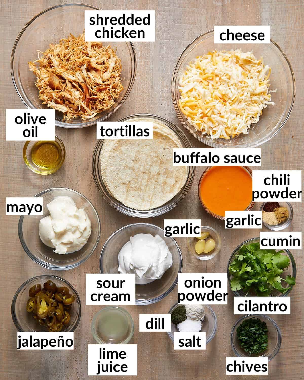 Ingredients needed to make buffalo chicken tacos in glass bowls.