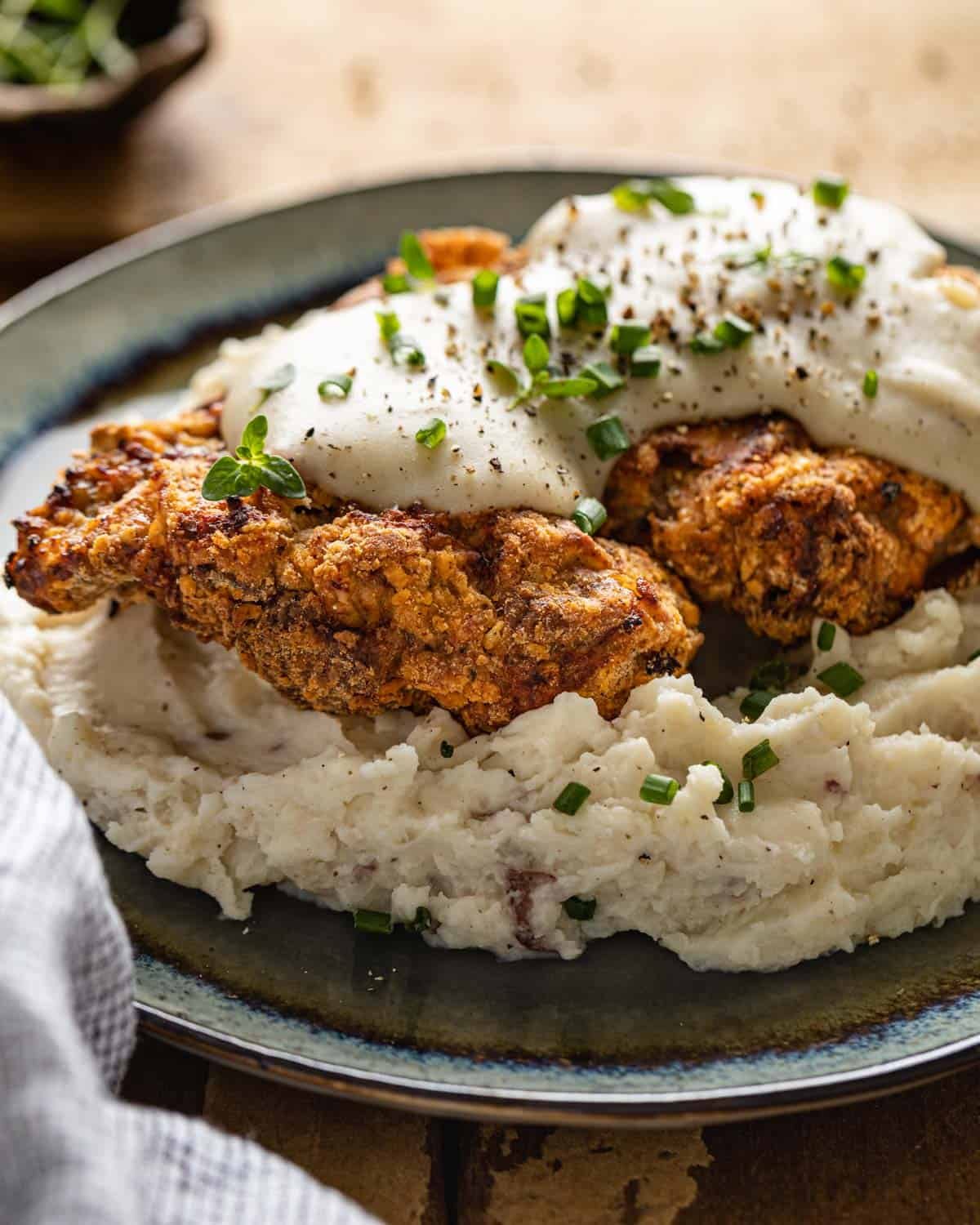 Air fryer chicken fried steak on a blue plate.