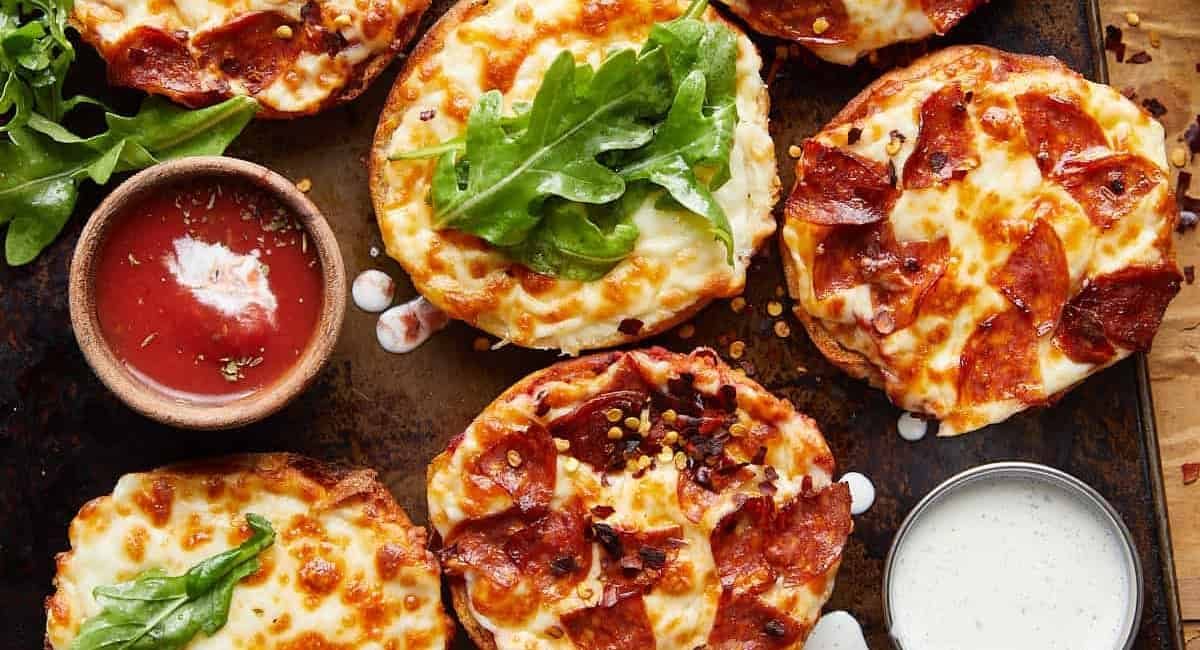 Overhead image of air fryer english muffin pizzas.