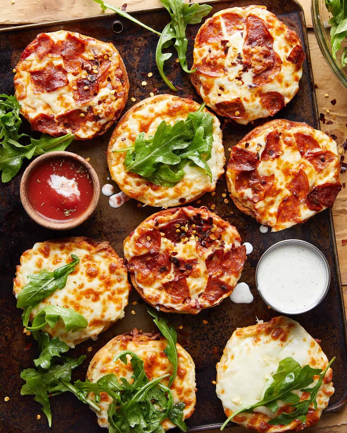 Overhead image of air fryer english muffin pizzas.
