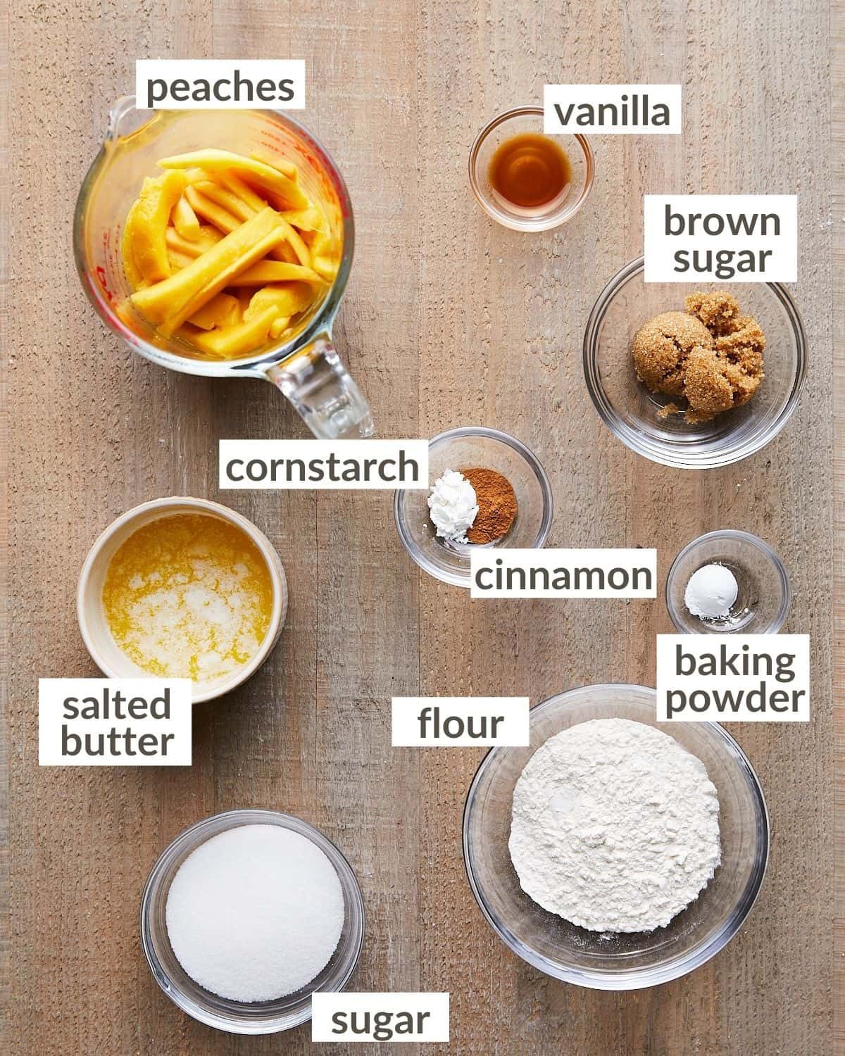 Overhead shot of ingredients for air fryer peach cobbler in glass bowls.