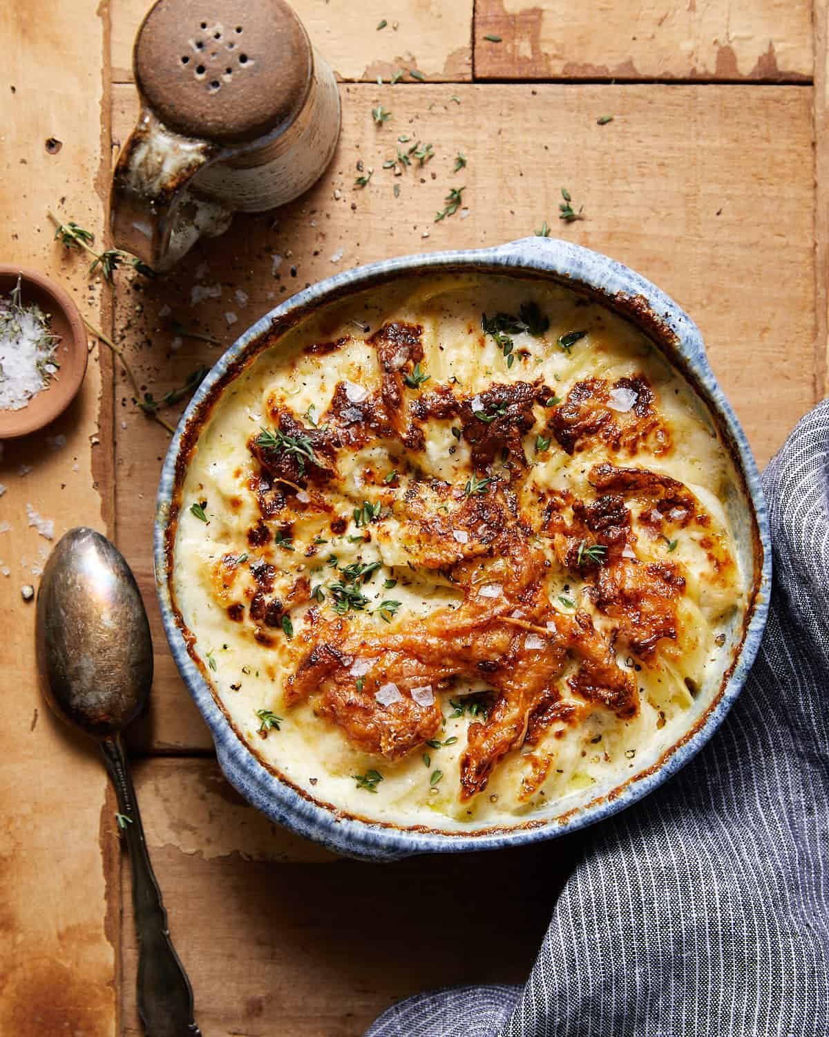 Air fryer scalloped potatoes in a blue dish.