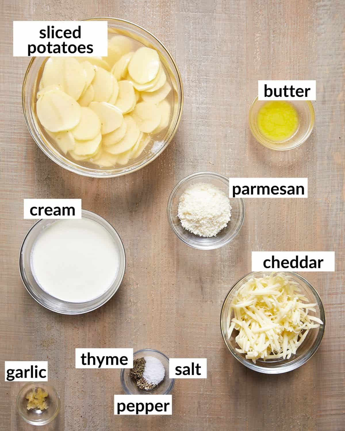 Ingredients needed to make air fryer scalloped potatoes in glass bowls.