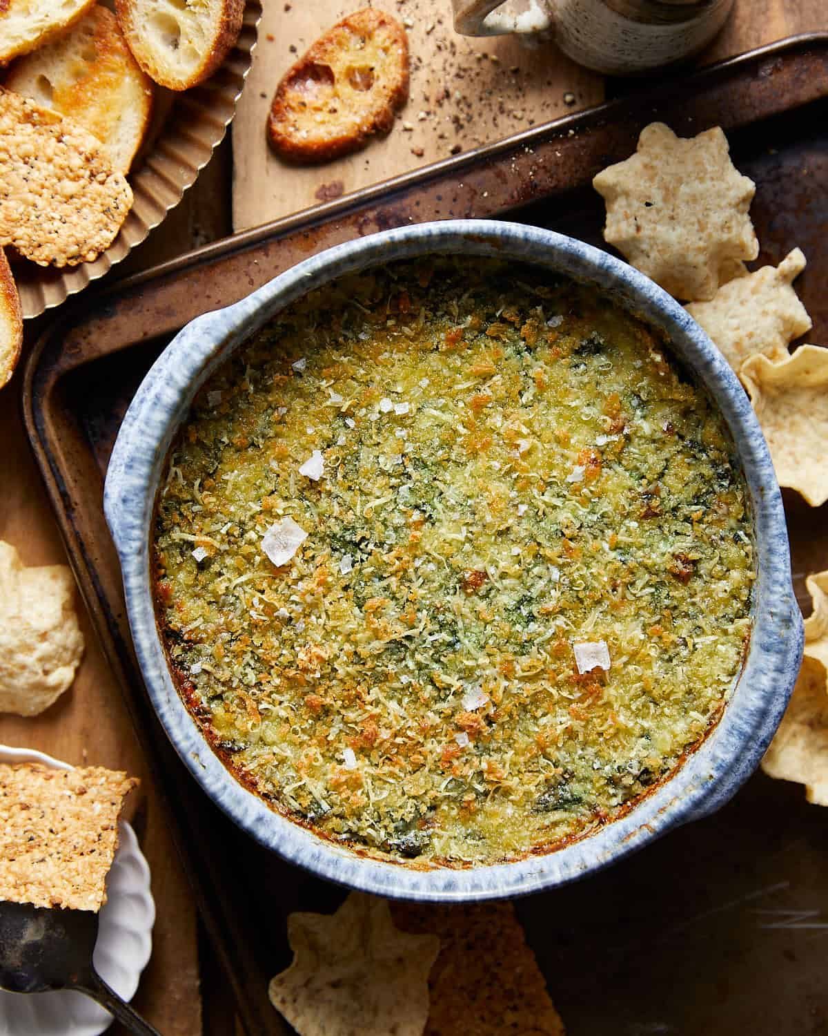 Final image of air fryer spinach dip in a blue bowl.