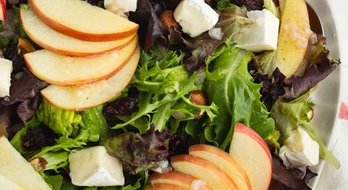 Overhead image of brie apple salad with shallot vinaigrette.