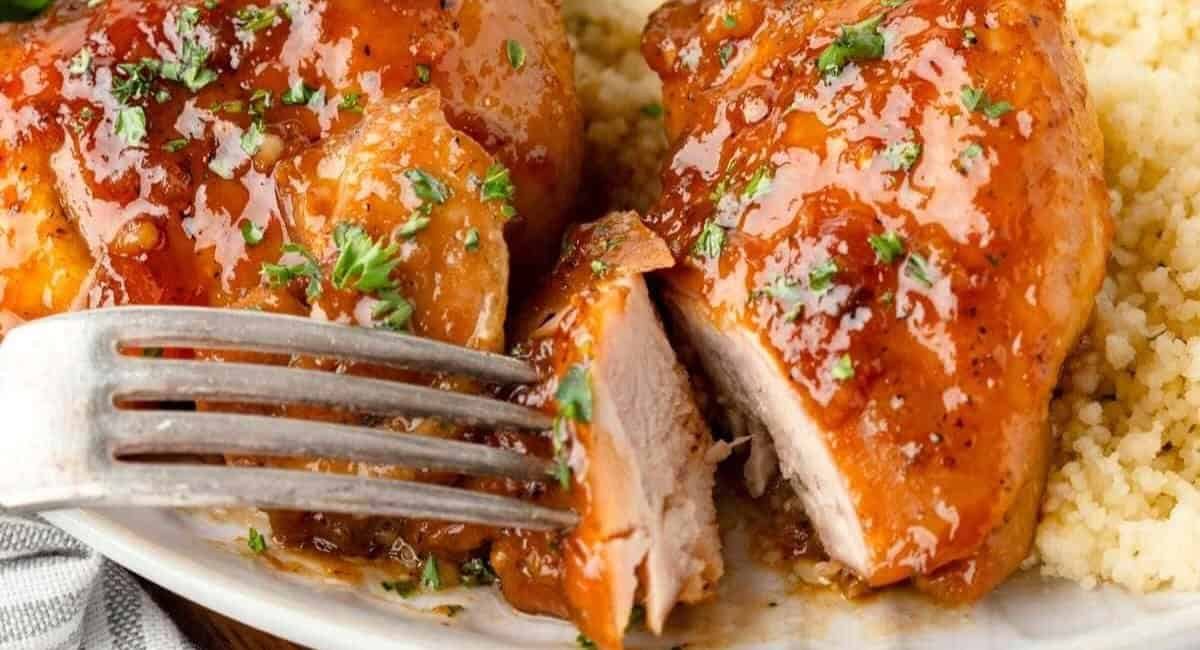 Up close image of old fashioned apricogt chicken with garnish.