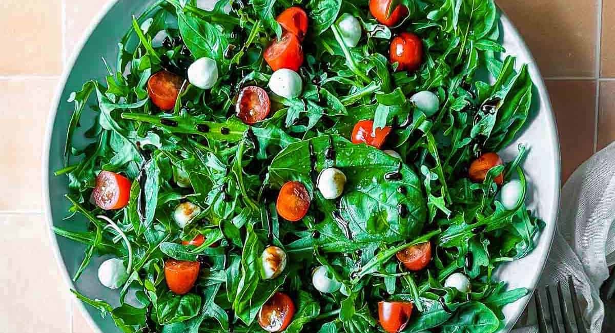 Overhead image of caprese salad with arugula.