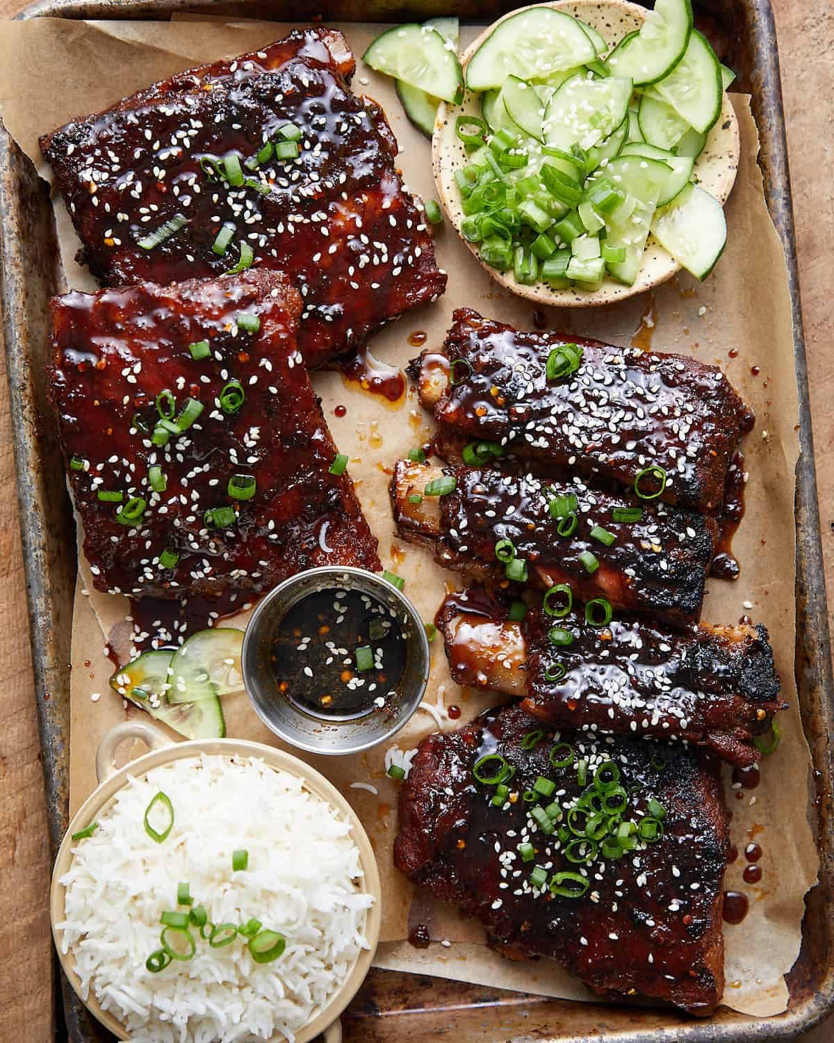 Overhead image of sticky asian ribs with garnish.