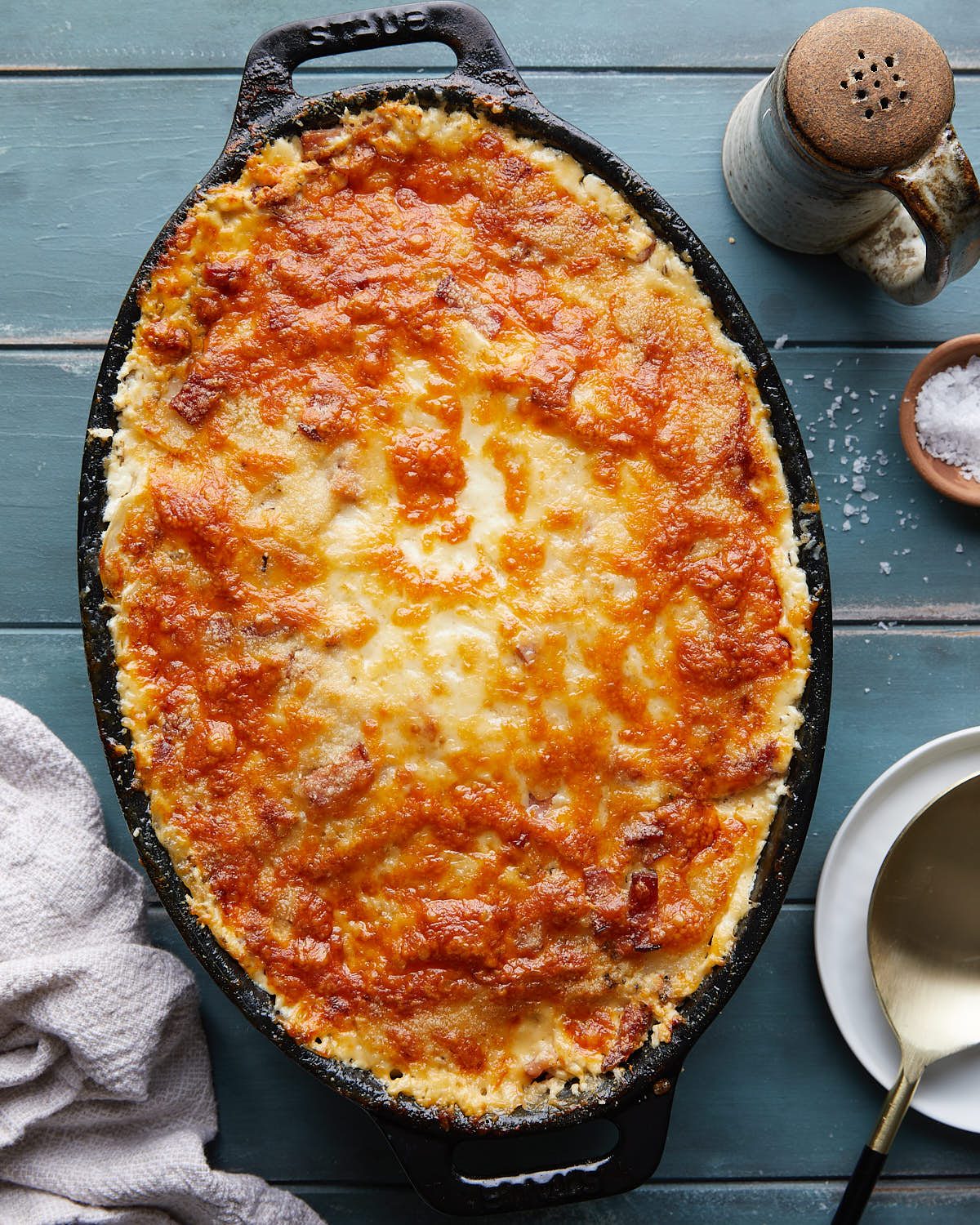 Overhead image of au gratin potatoes in black cast iron dish.