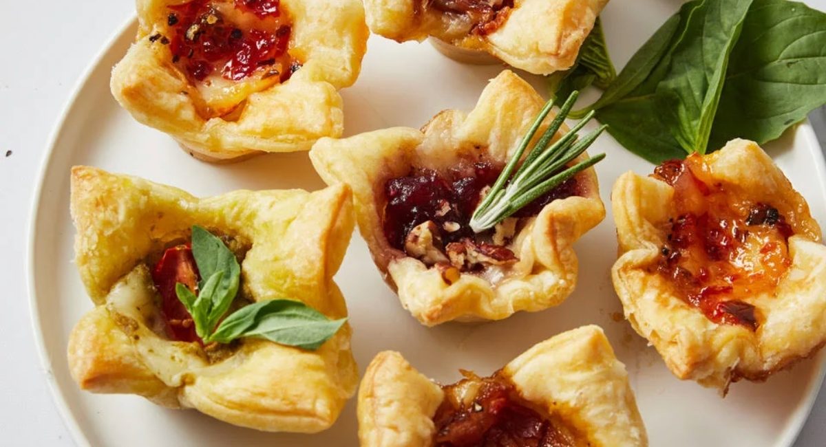 Overhead image of baked brie bites with garnish.