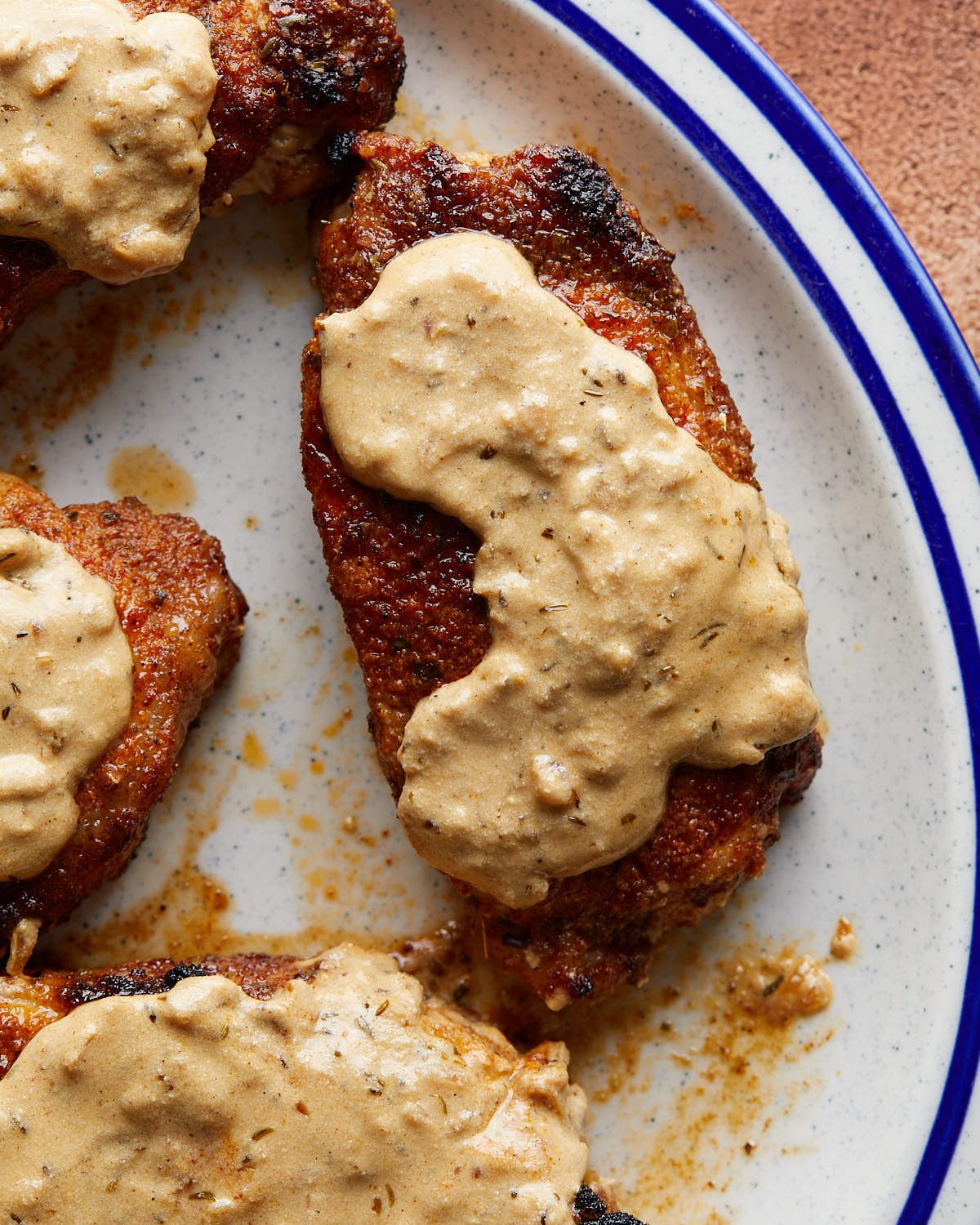 Up close image of oven baked boneless pork chop with creamy mustard sauce.