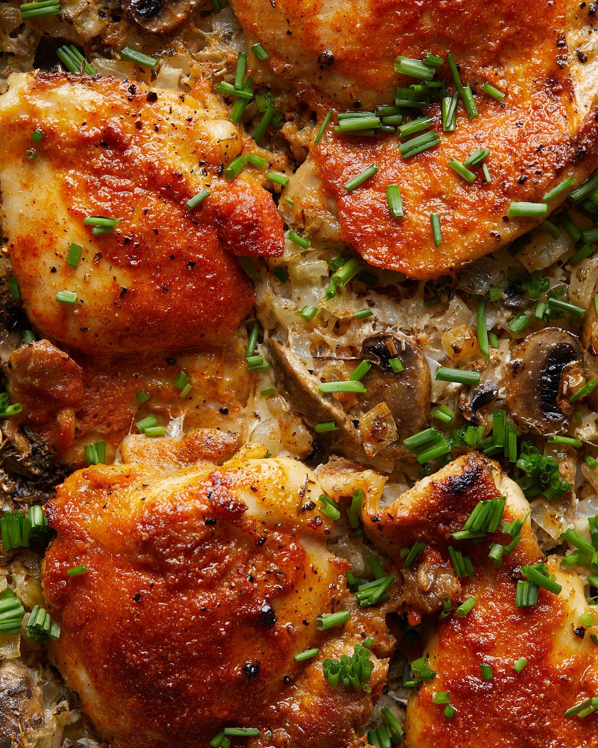Up close image of oven baked chicken and rice with garnish.