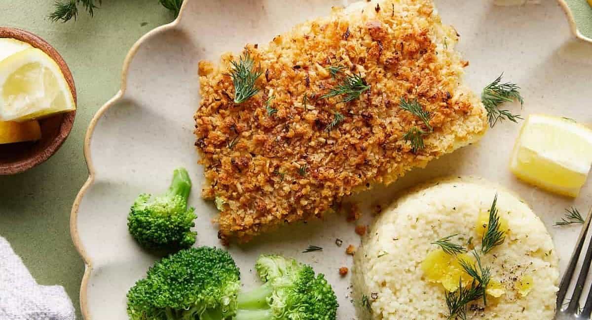 Overhead image of baked halibut with rice and broccoli side dishes.