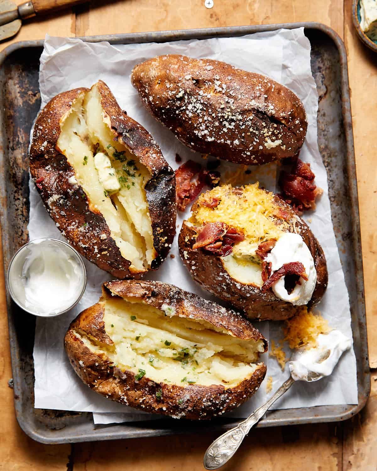 Overhead image of baked potatoes with garnish.