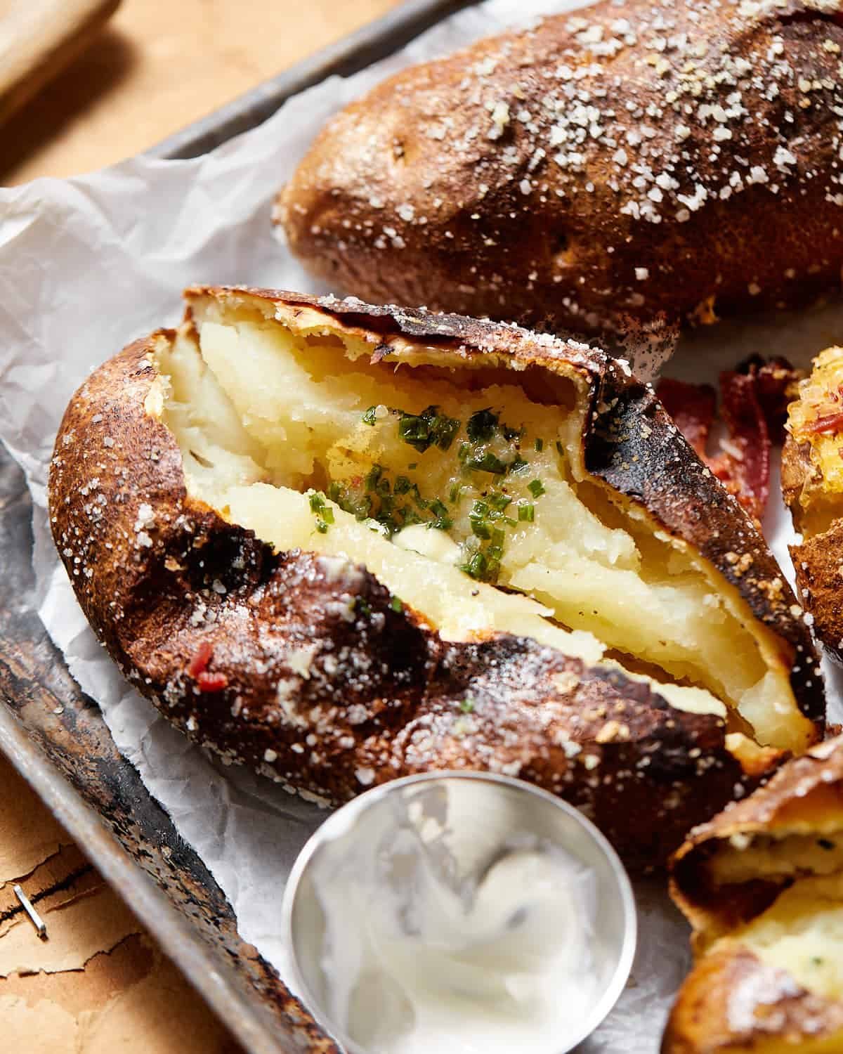 Up close photo of baked potato with garnish.