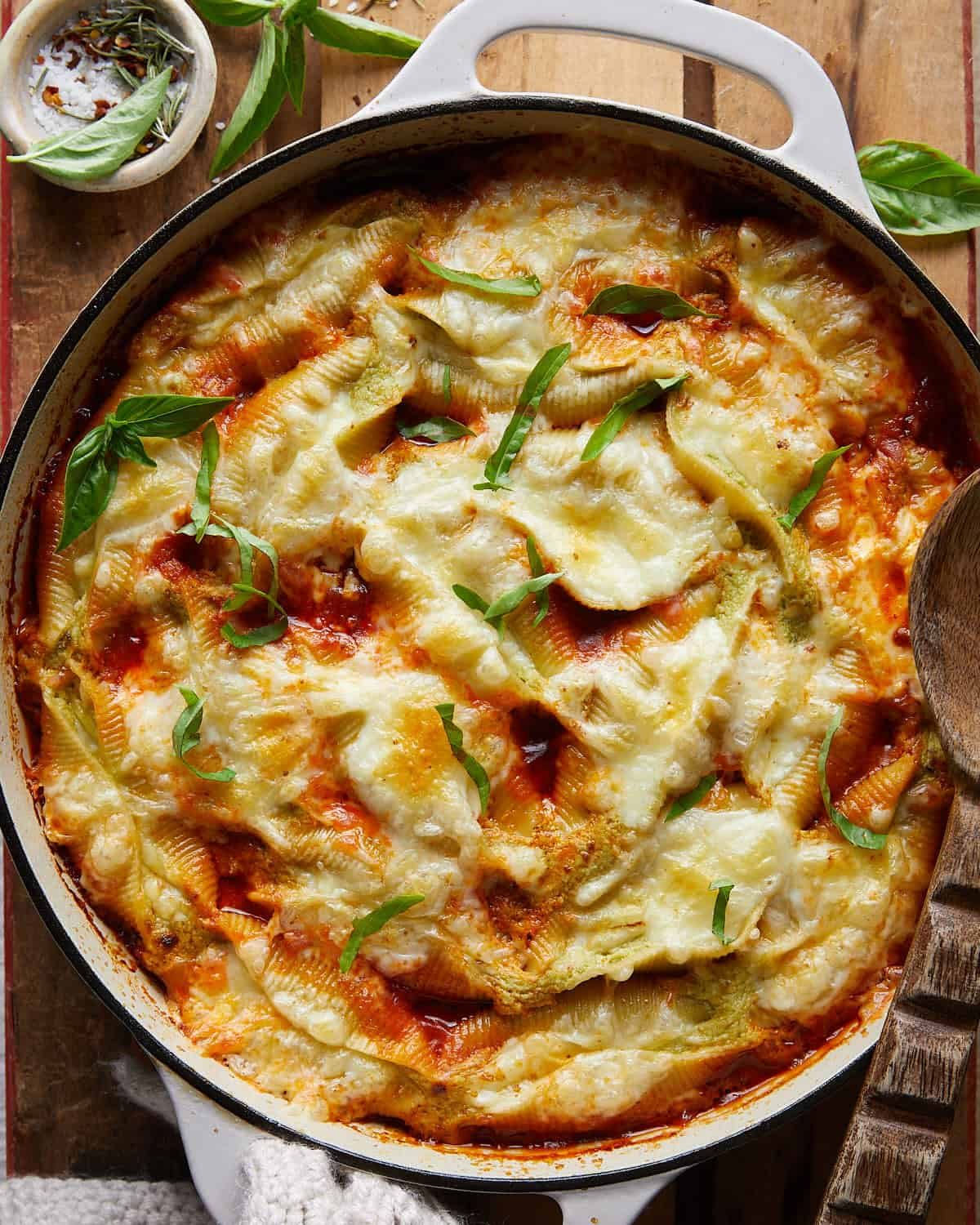 Cheesy baked stuffed shells in white casserole dish, homemade stuffed shells with ricotta and mozzarella, family-friendly dinner idea.