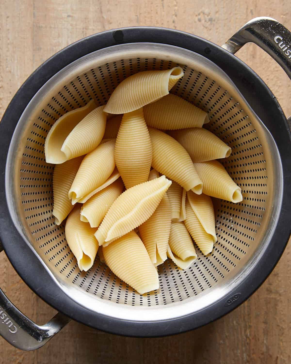 Boiled jumbo pasta shells prepared for baked stuffed shells, cooked until al dente and ready to fill.