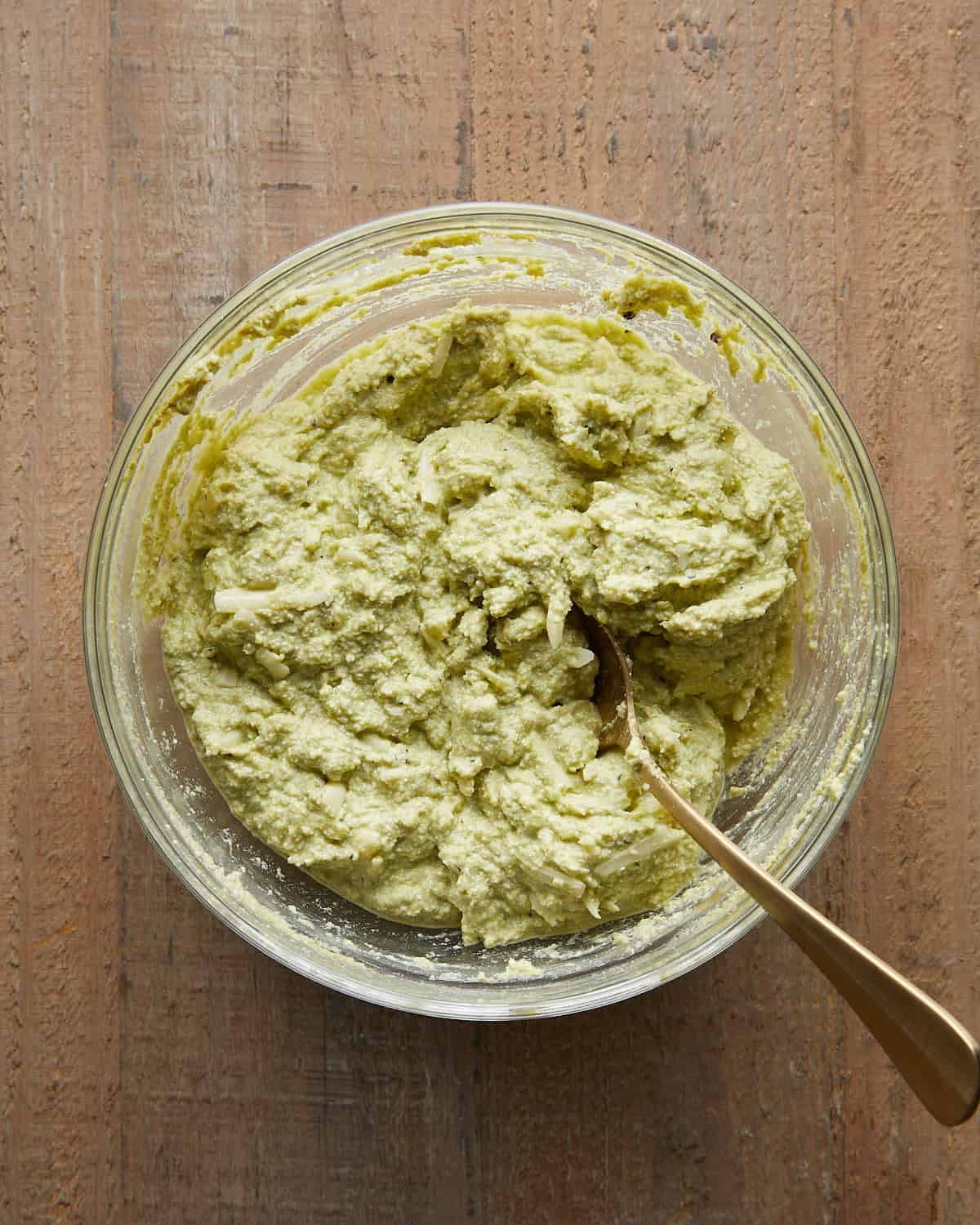 Ricotta and pesto mixture prepared to stuff shells for baked stuffed shells recipe.