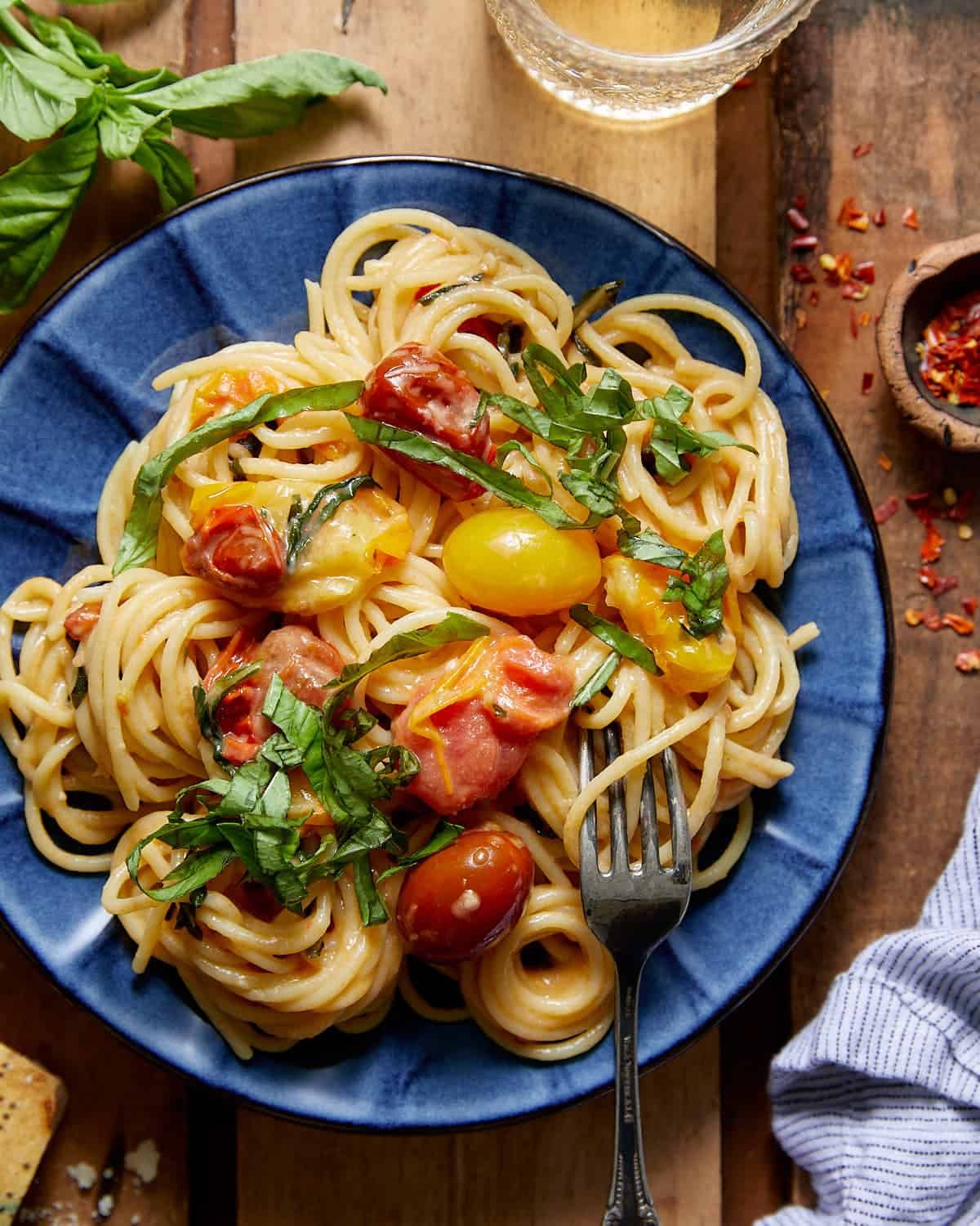 Tomato basil pasta on blue plate.