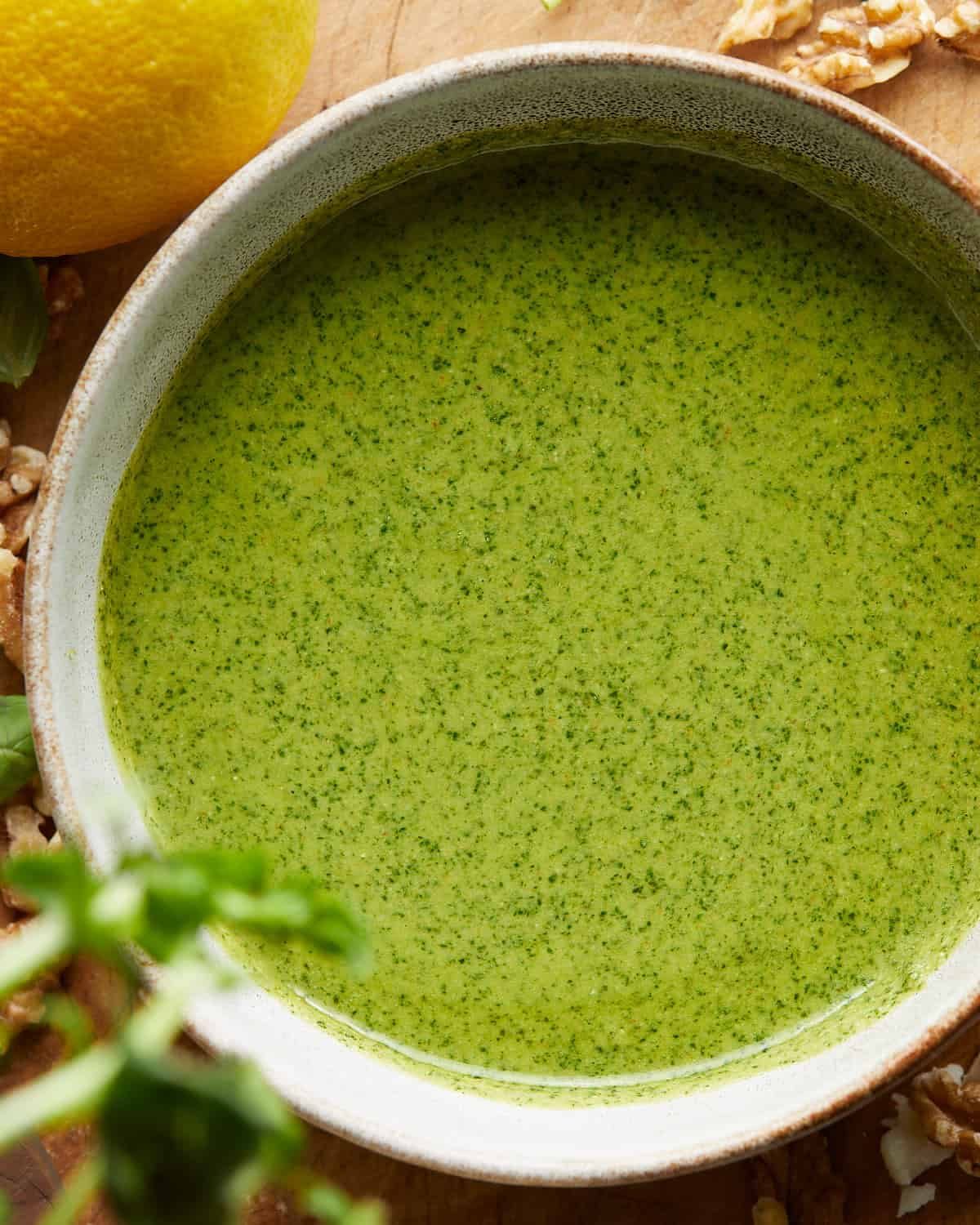 Up close image of pesto without pine nuts in bowl.