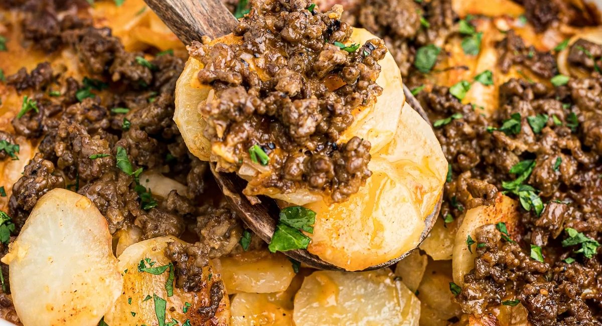 Up close image of slow cooker beef and potato au gratin with garnish.