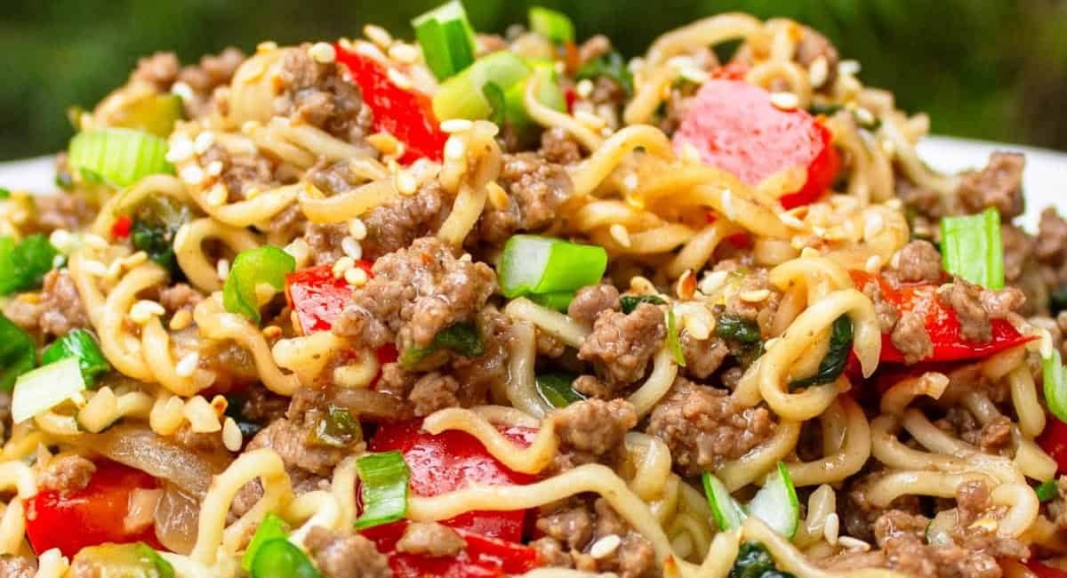 Up close image of beef noodles with veggies.