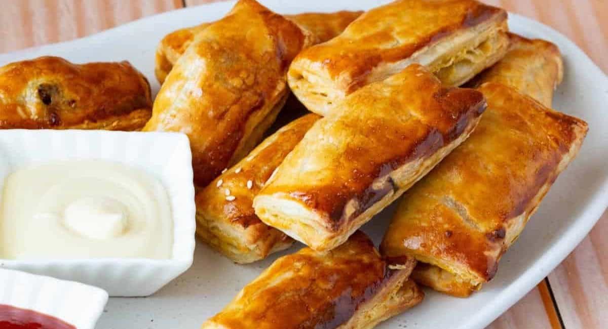 Up close image of meat stuffed puff pastry aka meat puffs.