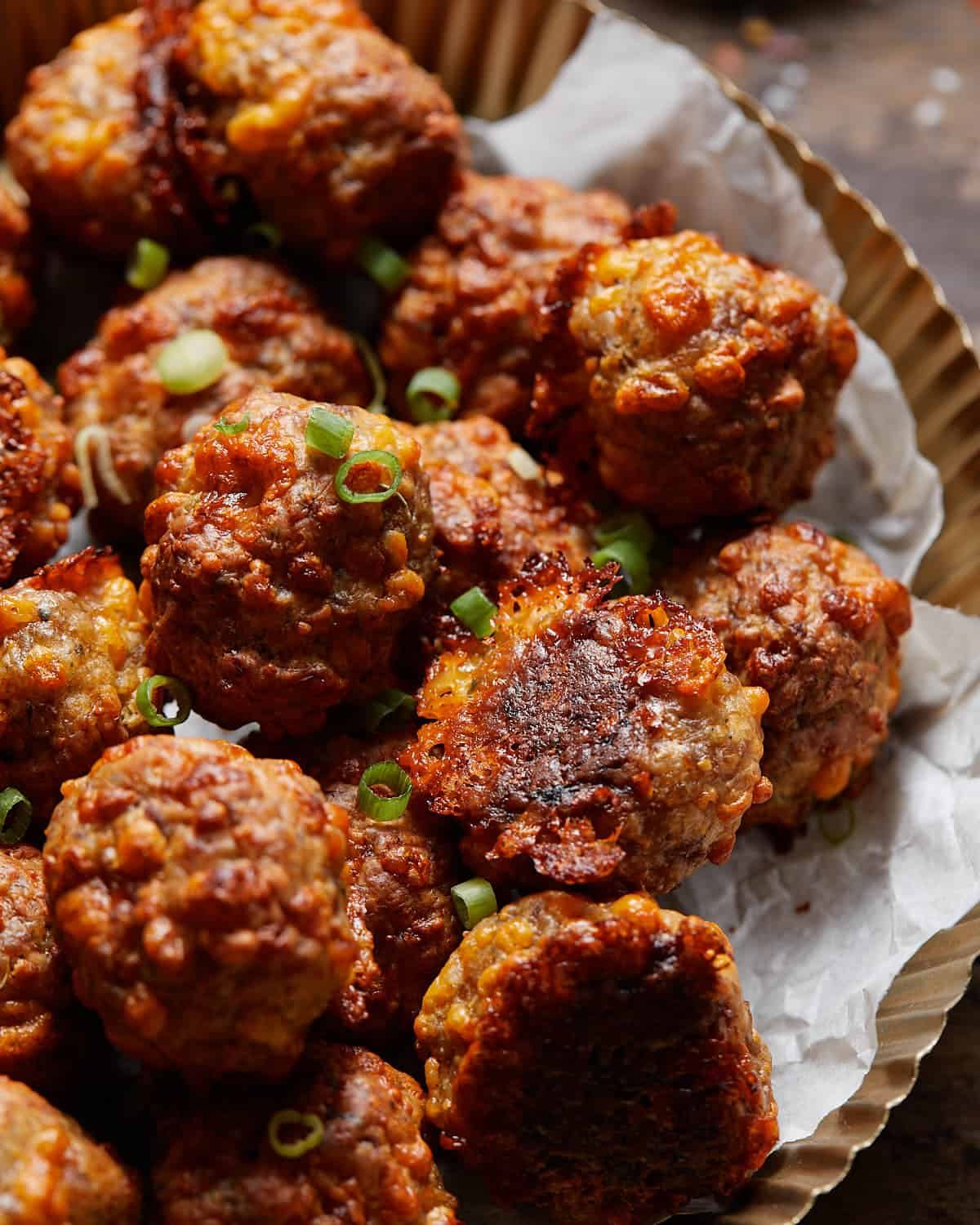 Sausage balls stacked up with a tray.
