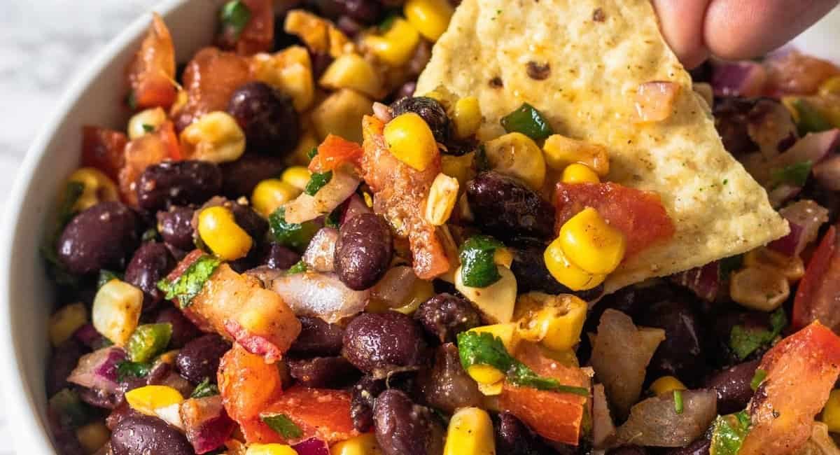 Overhead image of black bean and corn salsa with tortilla chip.