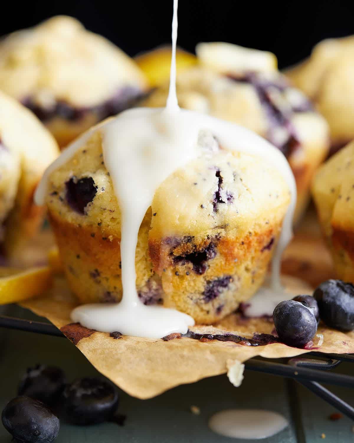 Up close image of blueberry lemon poppy seed muffin with glaze.