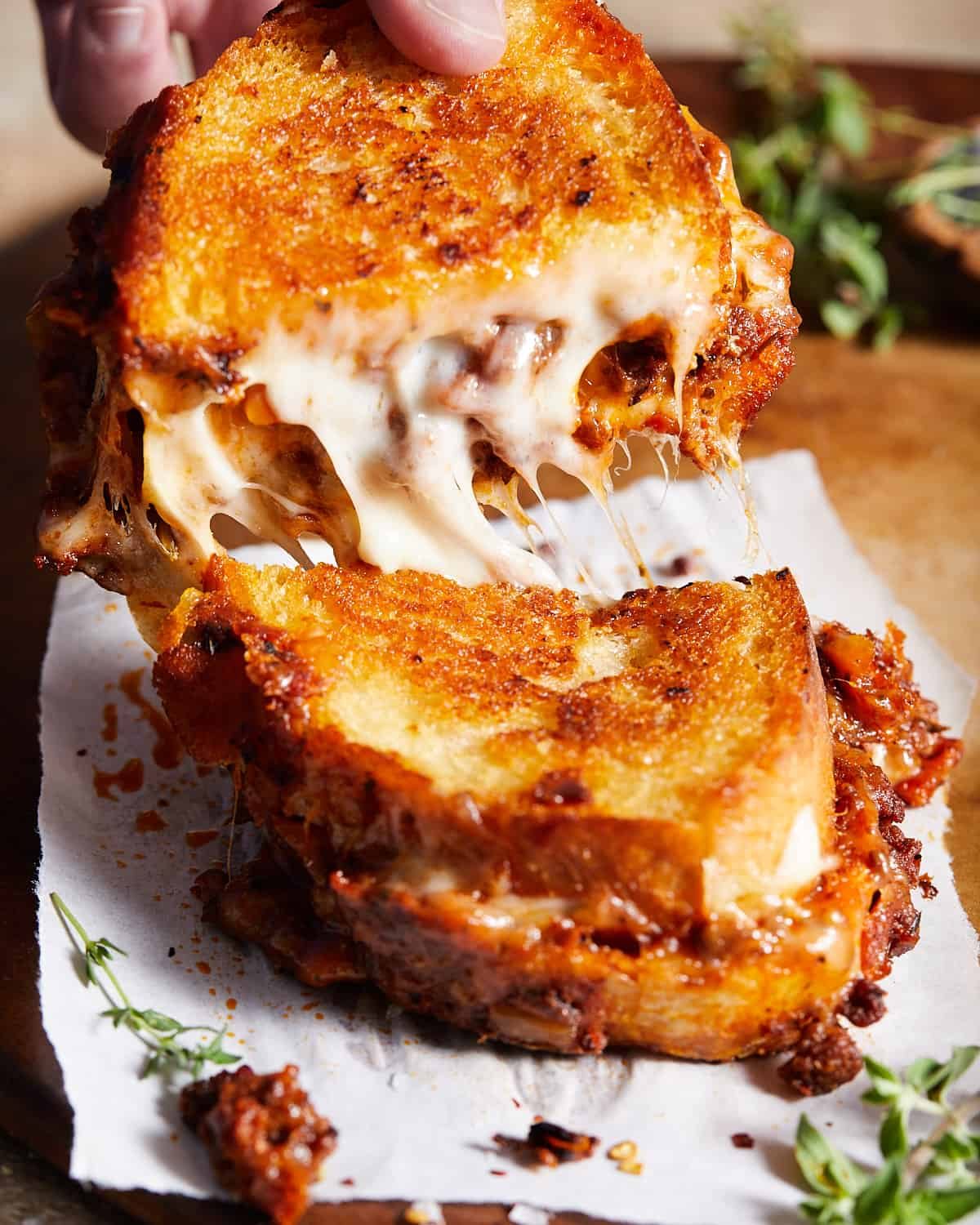 Bolognese sandwich cut in half being pulled apart.