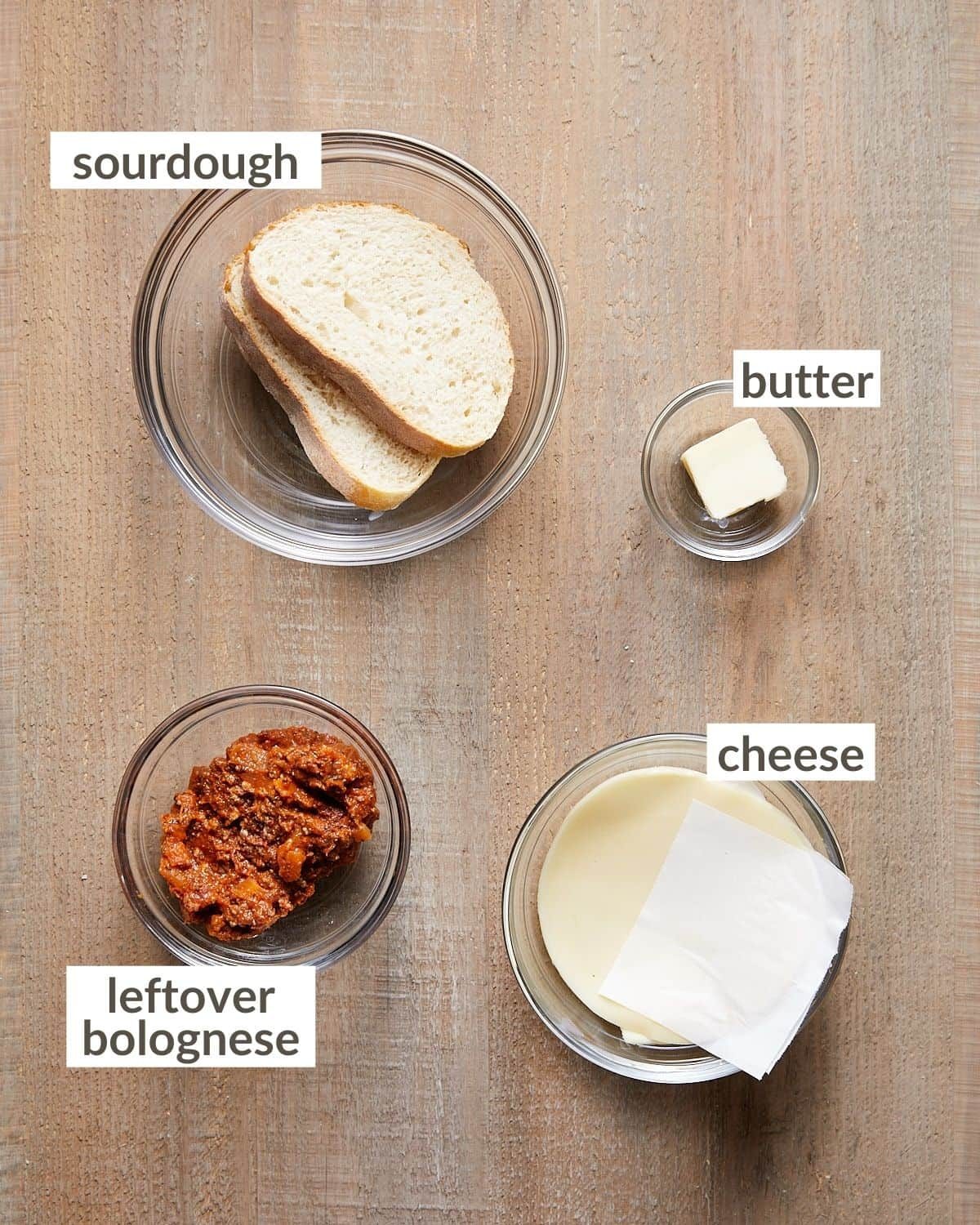 Ingredients needed for a bolognese sandwich in glass bowls.