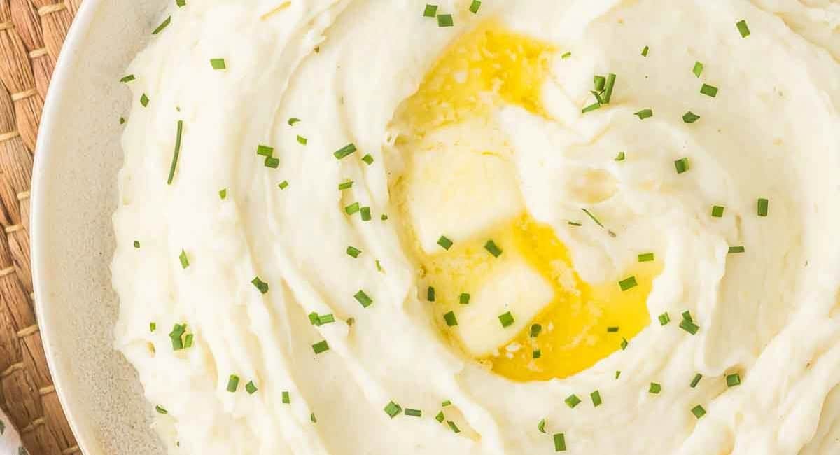 Overhead image of boursin mashed potatoes with garnish.