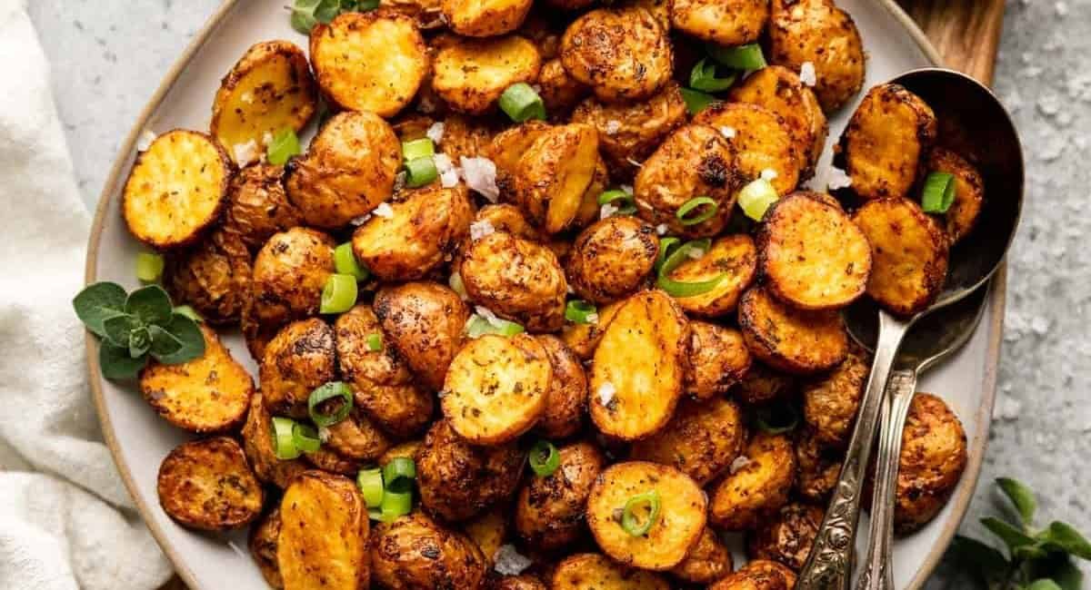 Overhead image of baby breakfast potatoes with garnish.