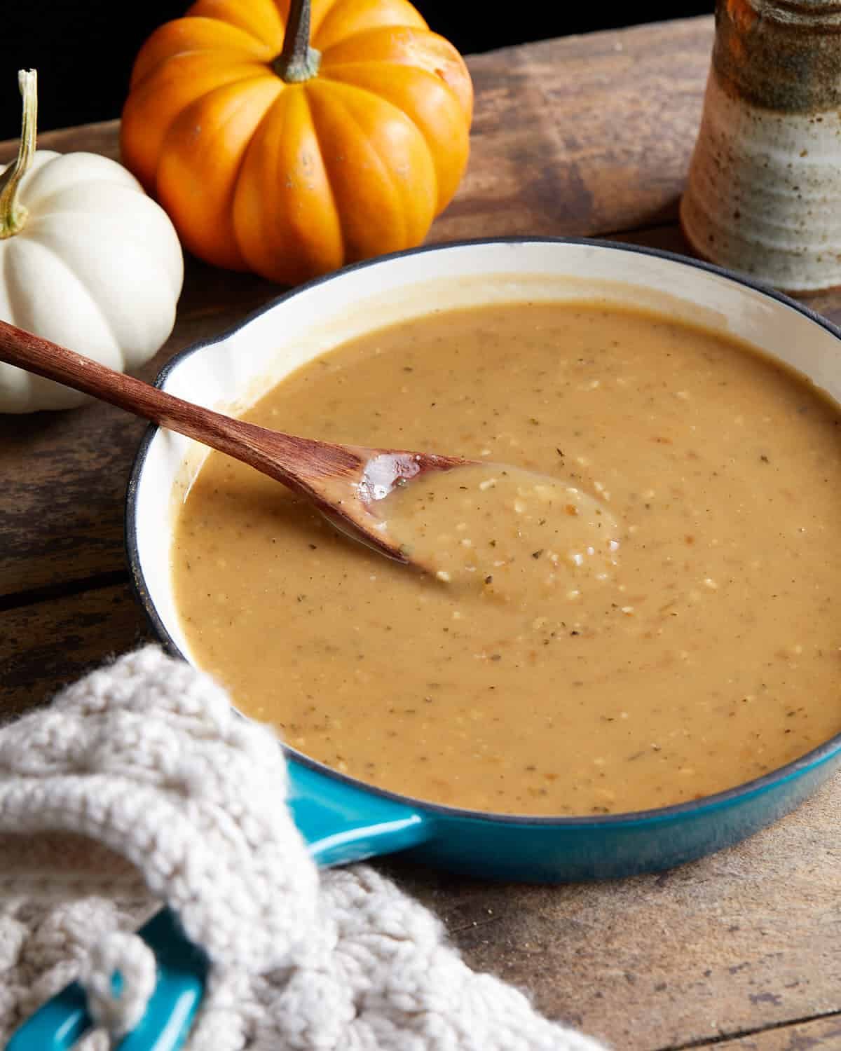 Overhead image of brown gravy in blue pan.