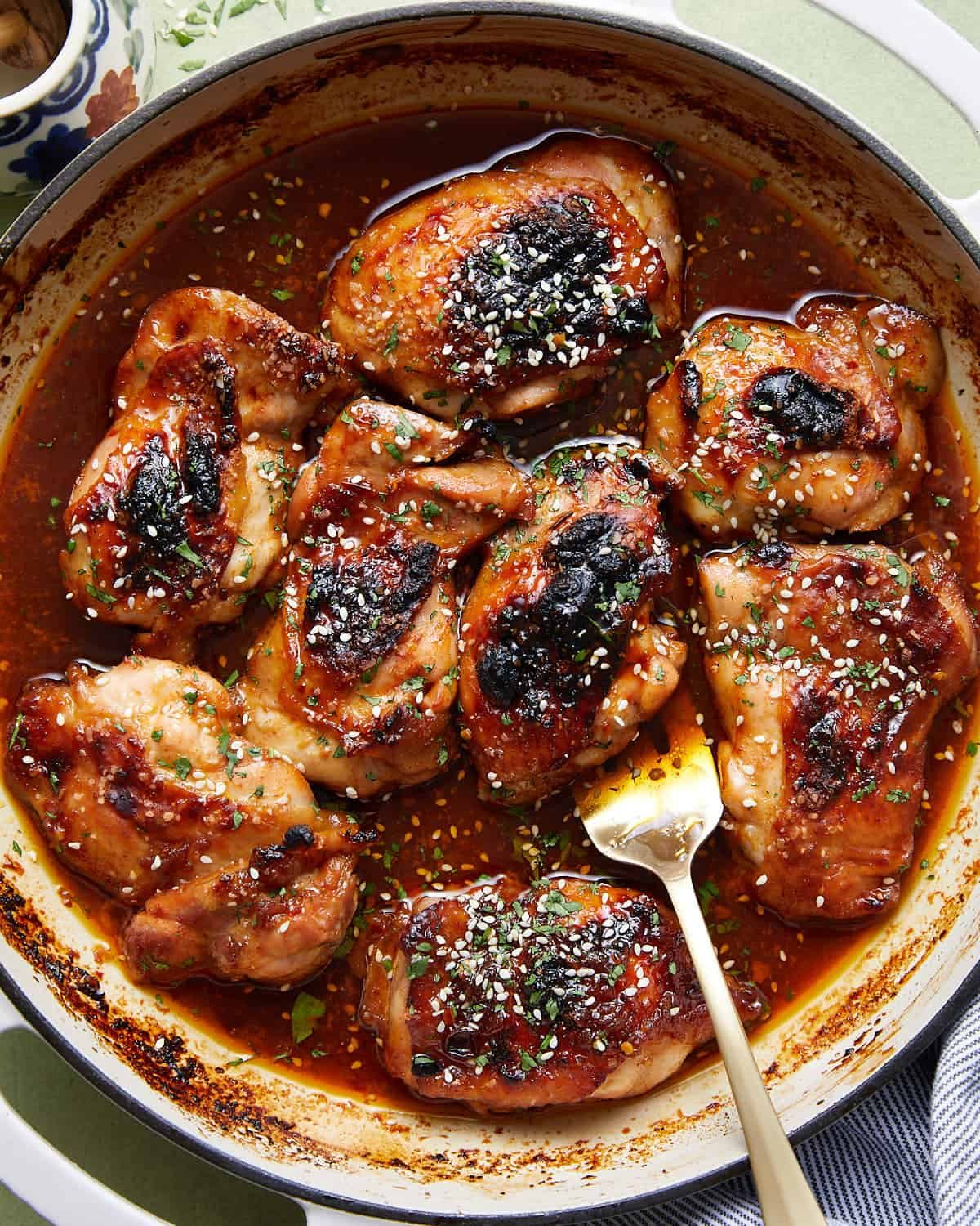 Overhead image of brown sugar garlic chicken in dutch oven with garnish.