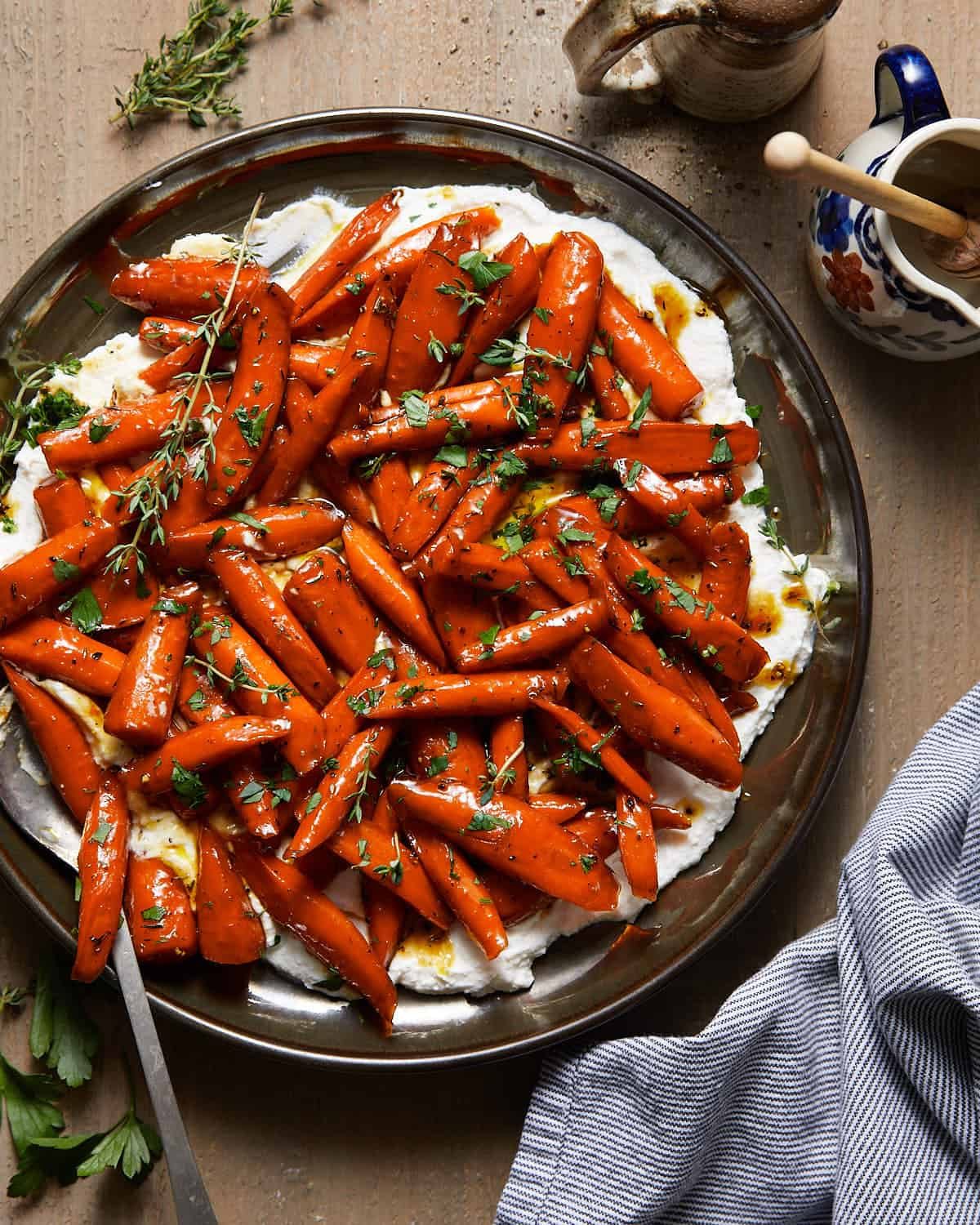 Brown sugar honey glazed carrots on a bed of ricotta cheese.